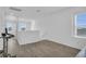 Bright, open bonus room with wood floors and natural light; perfect for flexible living at 11847 Brighton Knoll Loop, Riverview, FL 33579