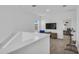 Upstairs bonus room with view, wood floors, and comfortable seating; ideal for recreation at 11847 Brighton Knoll Loop, Riverview, FL 33579