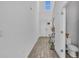 Bright foyer with a high ceiling, white door, and decorative table next to a powder room at 11847 Brighton Knoll Loop, Riverview, FL 33579