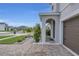 Inviting front porch and a well-manicured garden area with an attached two-car garage at 11847 Brighton Knoll Loop, Riverview, FL 33579