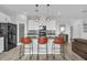 Modern kitchen featuring white cabinets, stainless appliances, pendant lighting and an island at 11847 Brighton Knoll Loop, Riverview, FL 33579