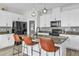 Modern kitchen featuring white cabinets, stainless appliances, pendant lighting and an island at 11847 Brighton Knoll Loop, Riverview, FL 33579