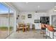 Eat-in kitchen with a view through a sliding door to the yard, island and white cabinets at 11847 Brighton Knoll Loop, Riverview, FL 33579