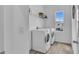 Convenient laundry room with modern white appliances and a storage shelf at 11847 Brighton Knoll Loop, Riverview, FL 33579