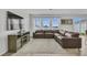 Stylish living room featuring lots of natural light, a large leather sofa and entertainment center at 11847 Brighton Knoll Loop, Riverview, FL 33579
