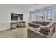 Cozy living room with neutral décor, large windows, and comfortable seating at 11847 Brighton Knoll Loop, Riverview, FL 33579