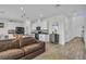 Bright living space featuring a leather sofa, white cabinets, and a stylish accent cabinet with a mirror at 11847 Brighton Knoll Loop, Riverview, FL 33579