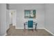 Office area displays a desk, an abstract art piece, neutral walls, and plank flooring at 11847 Brighton Knoll Loop, Riverview, FL 33579