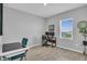 Neutral-toned office space provides natural light, space for two monitors, and modern, stylish furniture at 11847 Brighton Knoll Loop, Riverview, FL 33579