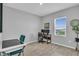Neutral-toned office space provides natural light, space for two monitors, and modern, stylish furniture at 11847 Brighton Knoll Loop, Riverview, FL 33579