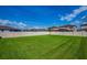 Spacious back yard featuring a well-maintained lawn and a privacy fence, ideal for outdoor activities at 12650 Shetland Walk Dr, Lithia, FL 33547