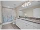 Large bathroom featuring dual sinks with granite counters and a shower-tub combination at 12650 Shetland Walk Dr, Lithia, FL 33547