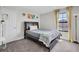 This staged bedroom features a large window, comfy bed, and decorative accents at 12650 Shetland Walk Dr, Lithia, FL 33547