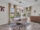 Elegant dining room with a modern chandelier, stylish curtains, and ample natural light at 12650 Shetland Walk Dr, Lithia, FL 33547