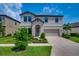 Charming two-story home with a well-manicured front yard and an attached two-car garage at 12650 Shetland Walk Dr, Lithia, FL 33547