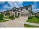 Stylish two-story home with a two-car garage, lush landscaping, and a neatly paved driveway at 12650 Shetland Walk Dr, Lithia, FL 33547