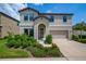 Charming two-story home featuring a manicured lawn and an attached two-car garage at 12650 Shetland Walk Dr, Lithia, FL 33547