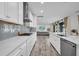 Spacious kitchen with grey backsplash, stainless appliances, and direct view to living room at 12650 Shetland Walk Dr, Lithia, FL 33547