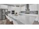 Stylish kitchen island with seating, pristine countertops, and stainless steel appliances at 12650 Shetland Walk Dr, Lithia, FL 33547