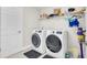 Bright laundry room with modern appliances, shelving, and ample storage space at 12650 Shetland Walk Dr, Lithia, FL 33547