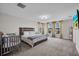 A large primary bedroom features neutral decor, large windows, and carpeting at 12650 Shetland Walk Dr, Lithia, FL 33547