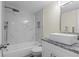 Bathroom with marble accent wall and granite countertop at 13046 Leverington St, Tampa, FL 33624