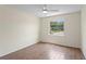 Bedroom with wood-look tile floors, ceiling fan, and natural light at 13046 Leverington St, Tampa, FL 33624