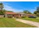 Beautiful brick home with lush green lawn, concrete driveway, and well-maintained landscaping at 13046 Leverington St, Tampa, FL 33624