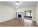 Bright living room with a tiled fireplace, wood-look floors, and sliding doors to the patio at 13046 Leverington St, Tampa, FL 33624