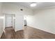 Bright living space featuring wood-look tile floors and neutral walls, leading to the kitchen at 13046 Leverington St, Tampa, FL 33624