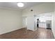 Bright living space featuring wood-look tile floors and neutral walls, leading to the kitchen at 13046 Leverington St, Tampa, FL 33624