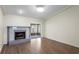Bright living room with a tiled fireplace, wood-look floors, and sliding doors to the patio at 13046 Leverington St, Tampa, FL 33624