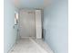 Inside the shed, the room is empty featuring blue walls, a white tiled floor, and small window at 13046 Leverington St, Tampa, FL 33624