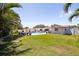 Large backyard with pool, lush lawn, and outdoor seating area, perfect for entertaining at 13168 84Th Ter, Seminole, FL 33776