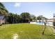 Expansive backyard with lush green lawn, pool area, and well-maintained landscaping at 13168 84Th Ter, Seminole, FL 33776