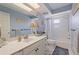 Traditional bathroom with a large mirror, white fixtures, and a shower-tub combination at 13168 84Th Ter, Seminole, FL 33776