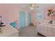 Cozy bedroom with pink walls, blue closet doors, and a comfortable bed at 13168 84Th Ter, Seminole, FL 33776