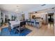 Open-concept dining room connecting to the kitchen with a breakfast bar and views to the living spaces at 13168 84Th Ter, Seminole, FL 33776