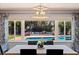 Dining room view with a glimpse of the refreshing pool and outdoor seating area through a large window at 13168 84Th Ter, Seminole, FL 33776