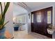 Welcoming foyer with a decorative front door, tile flooring, and a glimpse into the sunlit living area at 13168 84Th Ter, Seminole, FL 33776