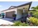 Exterior view showcasing the home's architectural details, including a two-car garage and meticulously landscaped front yard at 13168 84Th Ter, Seminole, FL 33776