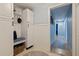 Inviting hallway with storage cabinets, a bench, and an open doorway to a well-lit area at 13168 84Th Ter, Seminole, FL 33776