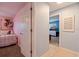 Hallway leading to a bedroom with a pink wall and a doorway to a blue-walled bedroom at 13168 84Th Ter, Seminole, FL 33776