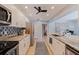 Bright kitchen featuring modern stainless steel appliances, white cabinets, and unique backsplash design at 13168 84Th Ter, Seminole, FL 33776