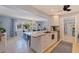 Open kitchen with a large granite island and breakfast bar, seamlessly flowing into the dining area at 13168 84Th Ter, Seminole, FL 33776