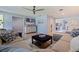 Open-concept living room featuring a comfortable sectional sofa, a large TV, and stylish coastal accents at 13168 84Th Ter, Seminole, FL 33776