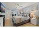 Comfortable main bedroom features a view of the outdoor patio, neutral colors, and access to the en suite bathroom at 13168 84Th Ter, Seminole, FL 33776