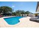 Sparkling pool surrounded by lush tropical landscaping and comfortable patio seating at 13168 84Th Ter, Seminole, FL 33776