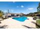 Backyard view of a sparkling pool with lounge area and well-maintained landscaping at 13168 84Th Ter, Seminole, FL 33776