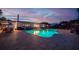 Backyard pool illuminated at dusk, highlighting the outdoor living space of the home at 13168 84Th Ter, Seminole, FL 33776